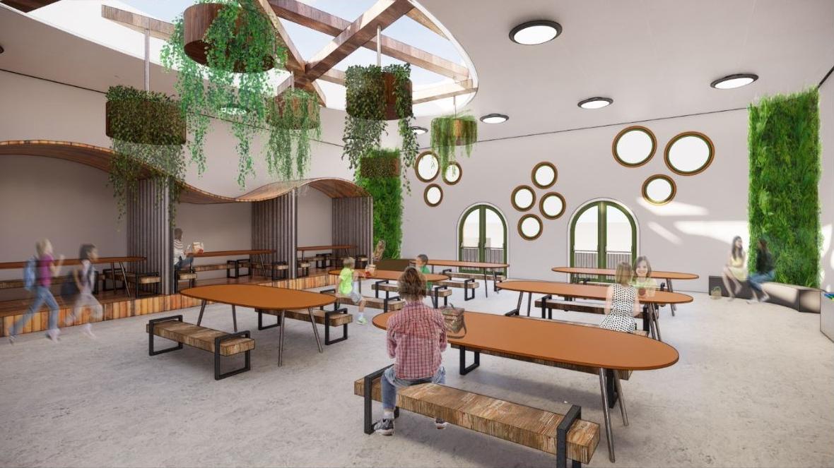 学校食堂的效果图，椭圆形的桌子和悬挂的植物.